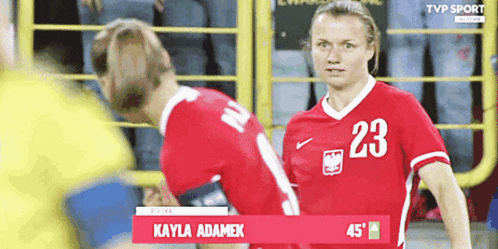 a female soccer player wearing a red jersey with the number 23 on it