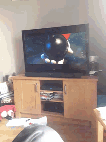 a tv shows a cartoon character holding a ball