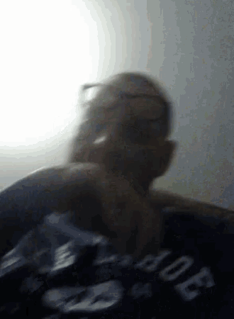 a blurry picture of a man wearing a shirt that says ' abercrombie & fitch '