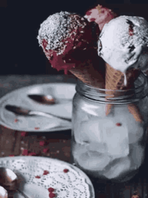 three ice cream cones in a jar with ice cubes