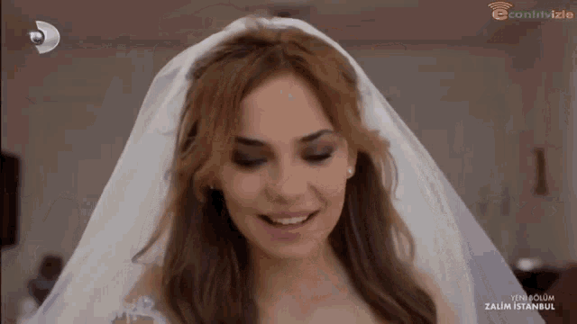 a woman in a wedding dress is smiling in front of a screen that says zalim istanbul on it