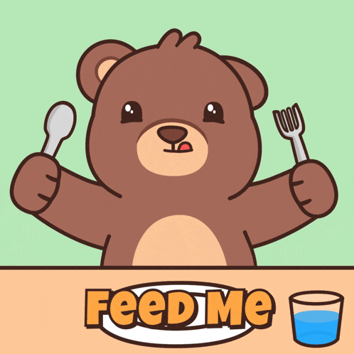 a teddy bear is sitting at a table holding a spoon and fork and says feed me