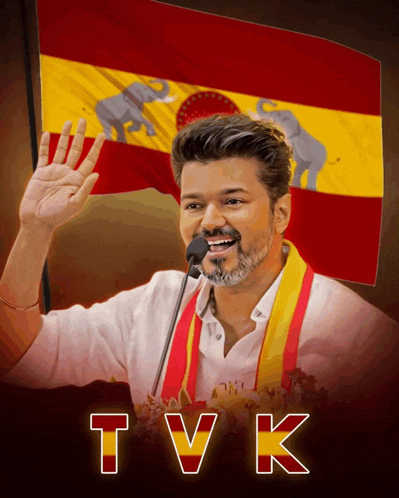 a man holds a microphone in front of a spanish flag with the letters tvk on the bottom