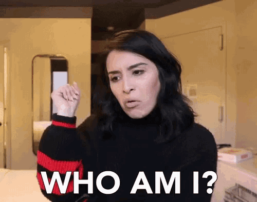 a woman in a black and red striped sweater says who am i