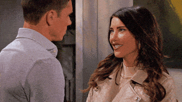 a man and a woman are looking at each other