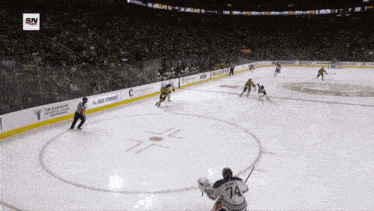 a hockey game is being played in a stadium sponsored by yamaha and geico