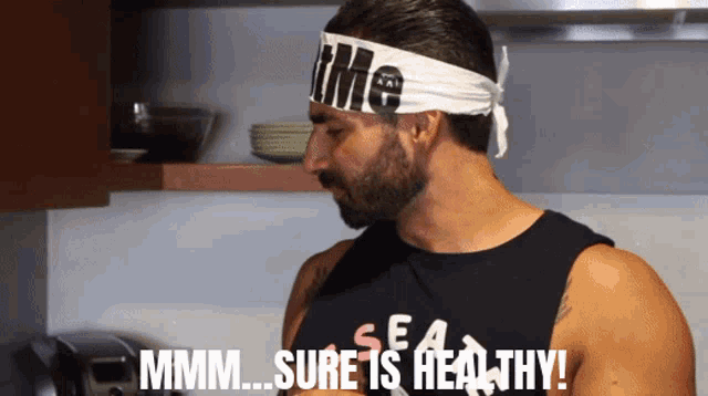 a man wearing a headband that says i me on it