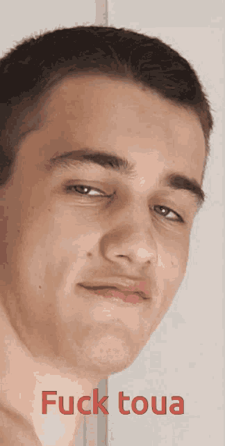 a close up of a man 's face with the words " fuck toua " on the bottom