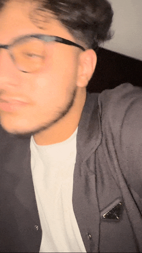 a blurry photo of a man wearing glasses