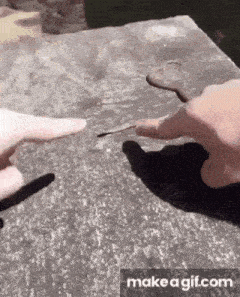 a person is holding a piece of metal in their hand .