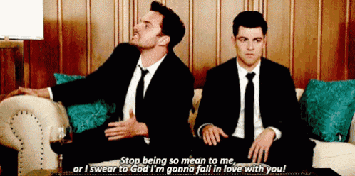 two men in suits and ties are sitting on a couch and one of them says " stop being so mean to me "