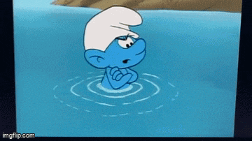 a smurf is standing in a body of water .