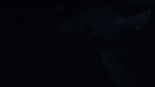 a group of anime girls are standing in a dark room .