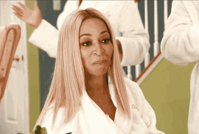 a woman wearing a white robe with the letters aa on it
