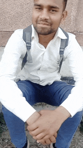 a man with a backpack on his back is sitting down