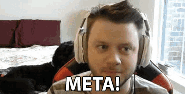 a man wearing headphones is sitting in a chair with a dog behind him .