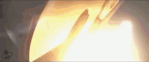 a close up of a rocket flying through the air with a glowing light coming out of it .