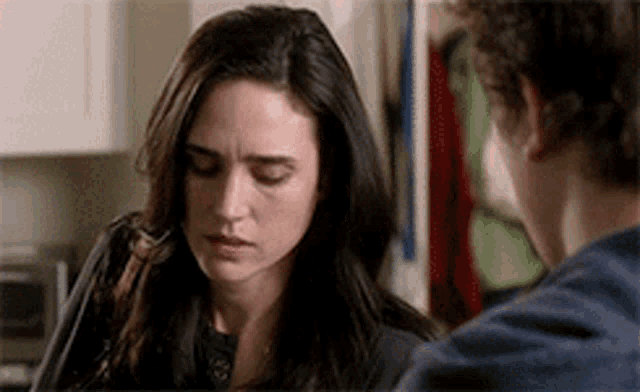a man and a woman are looking at each other .