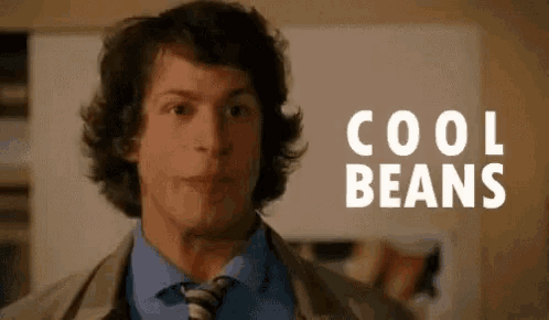 a man in a suit and tie is standing in front of the words cool beans .