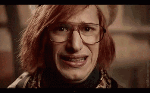a close up of a person wearing glasses and braces making a sad face