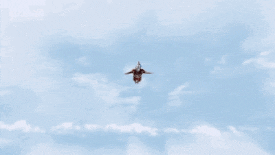 a man in a red suit is flying through the air surrounded by a bunch of rings .