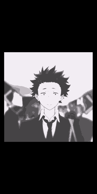 a black and white photo of a boy in a suit and tie standing in a crowd of people .