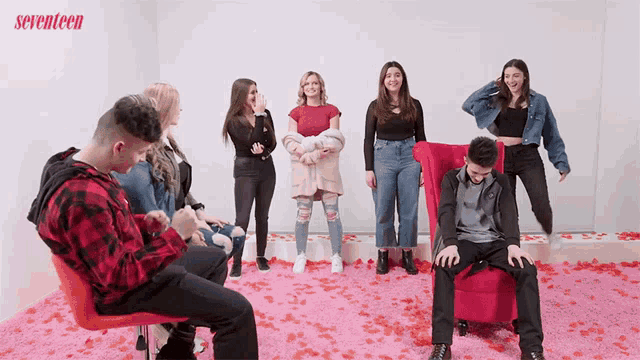 a group of people are standing in a room with seventeen written on the bottom right