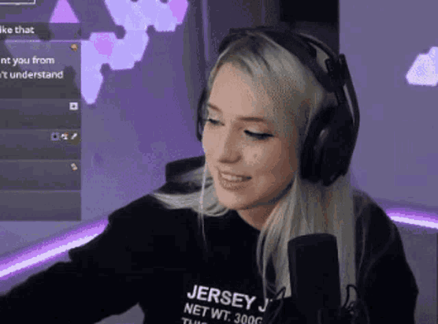 a woman wearing headphones and a black shirt that says jersey
