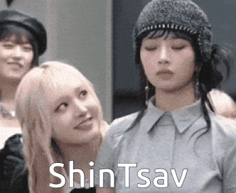 a group of women are standing next to each other and one of them is wearing a beanie .