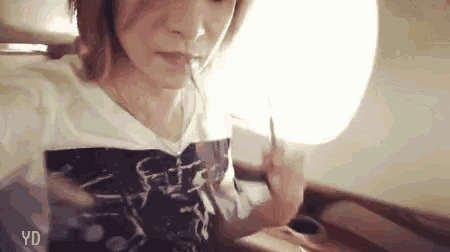 a woman is taking a selfie on an airplane while eating food .