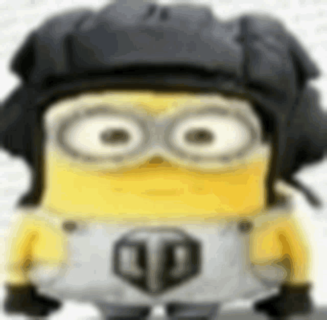 a yellow minion wearing a black helmet and goggles .
