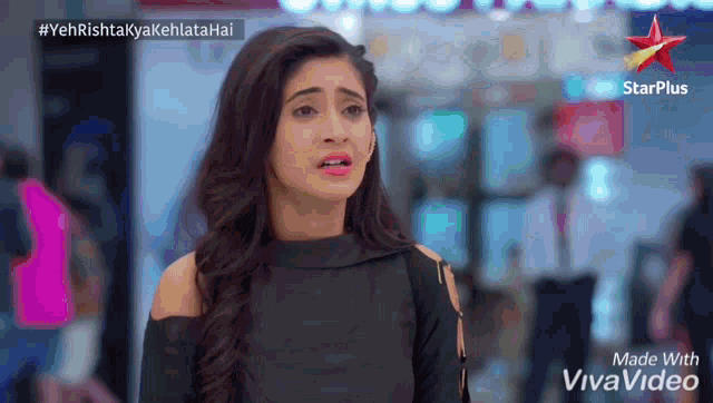 a woman is standing in front of a starplus sign