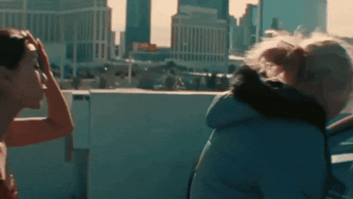 a group of people are looking out over a city skyline