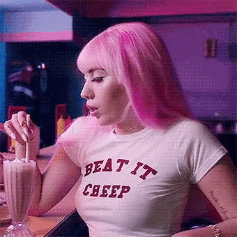 a woman with pink hair wearing a beat it creep t-shirt