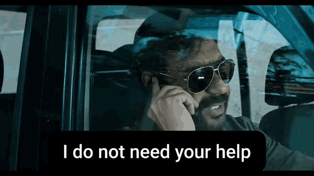 a man wearing sunglasses is talking on a cell phone with the caption i do not need your help below him