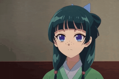 a girl with green hair and blue eyes is looking at the camera