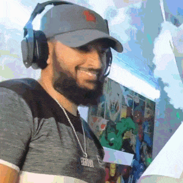 a man with a beard wearing headphones and a necklace with the word spiderman on it