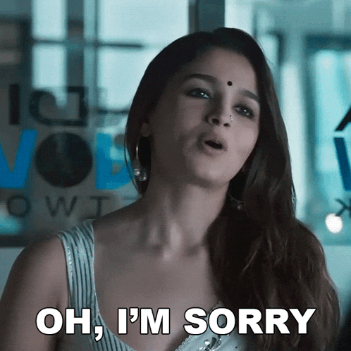 a woman is saying oh i 'm sorry in front of a window