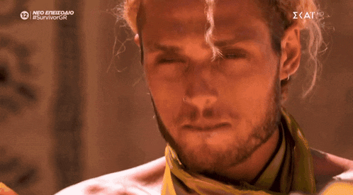 a close up of a man 's face with a yellow scarf around his neck that says neo epizedio #survivor on it