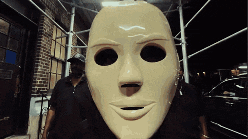 a man wearing a mask with a smile on it