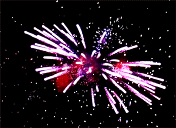 a fireworks display in the night sky with a red star in the center