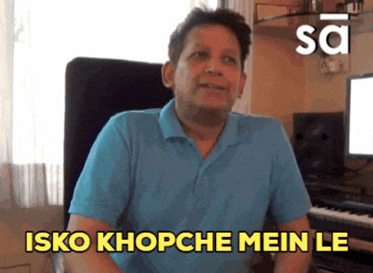 a man in a blue shirt says isko khopche mein le in yellow letters