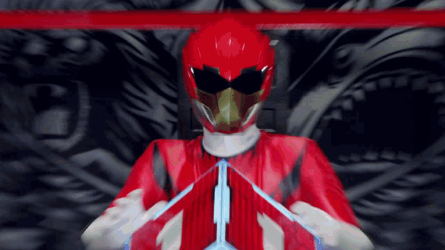 a red power ranger is holding a blue arrow