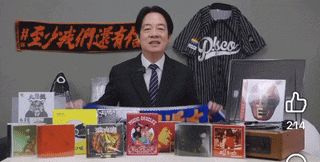 a man in a suit and tie is holding a scarf in front of a sign that says disco
