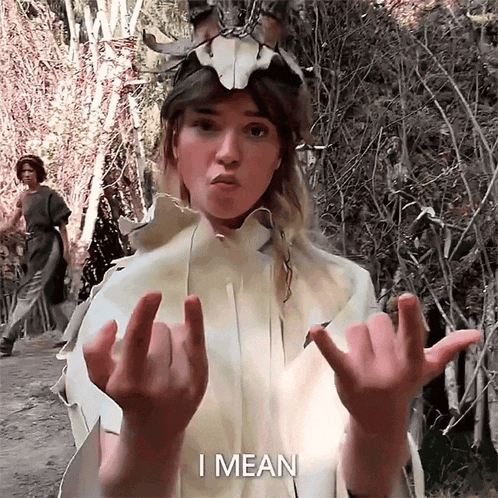 a woman making a funny face with the words i mean behind her