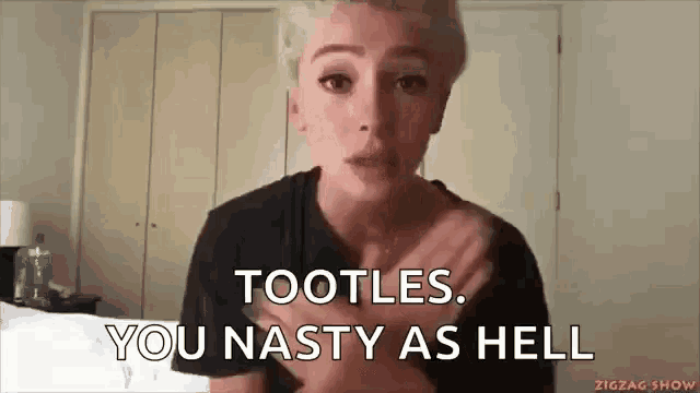 a woman is making a funny face while holding her chest and saying tootles . you nasty as hell .