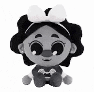 a black and white photo of a stuffed animal with a bow .