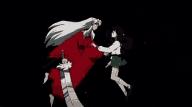 a man and a woman are standing next to each other in the dark .