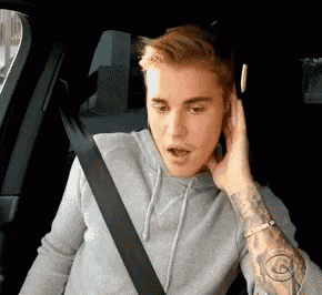 a man wearing headphones is sitting in a car