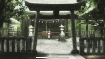 a woman is standing in front of a shrine in a forest .
